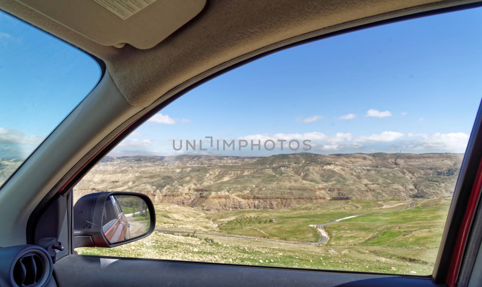 View through the window of a rental car to the edge of Dana Biosphere Reserve, Jordan, middle east