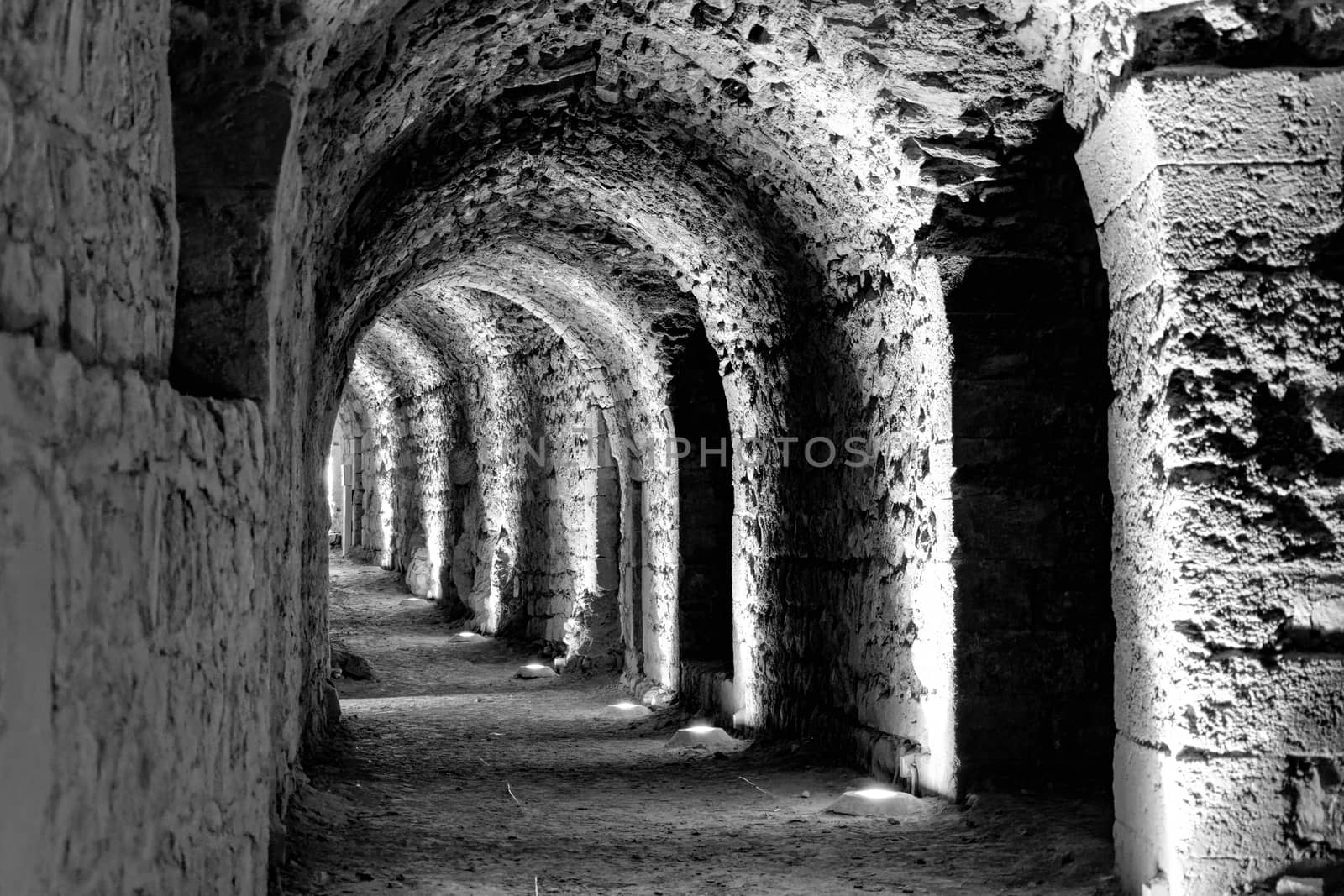 Black and white developed photo of the interior of the castle Karak with electric lights attached for the tourists and visitors by geogif