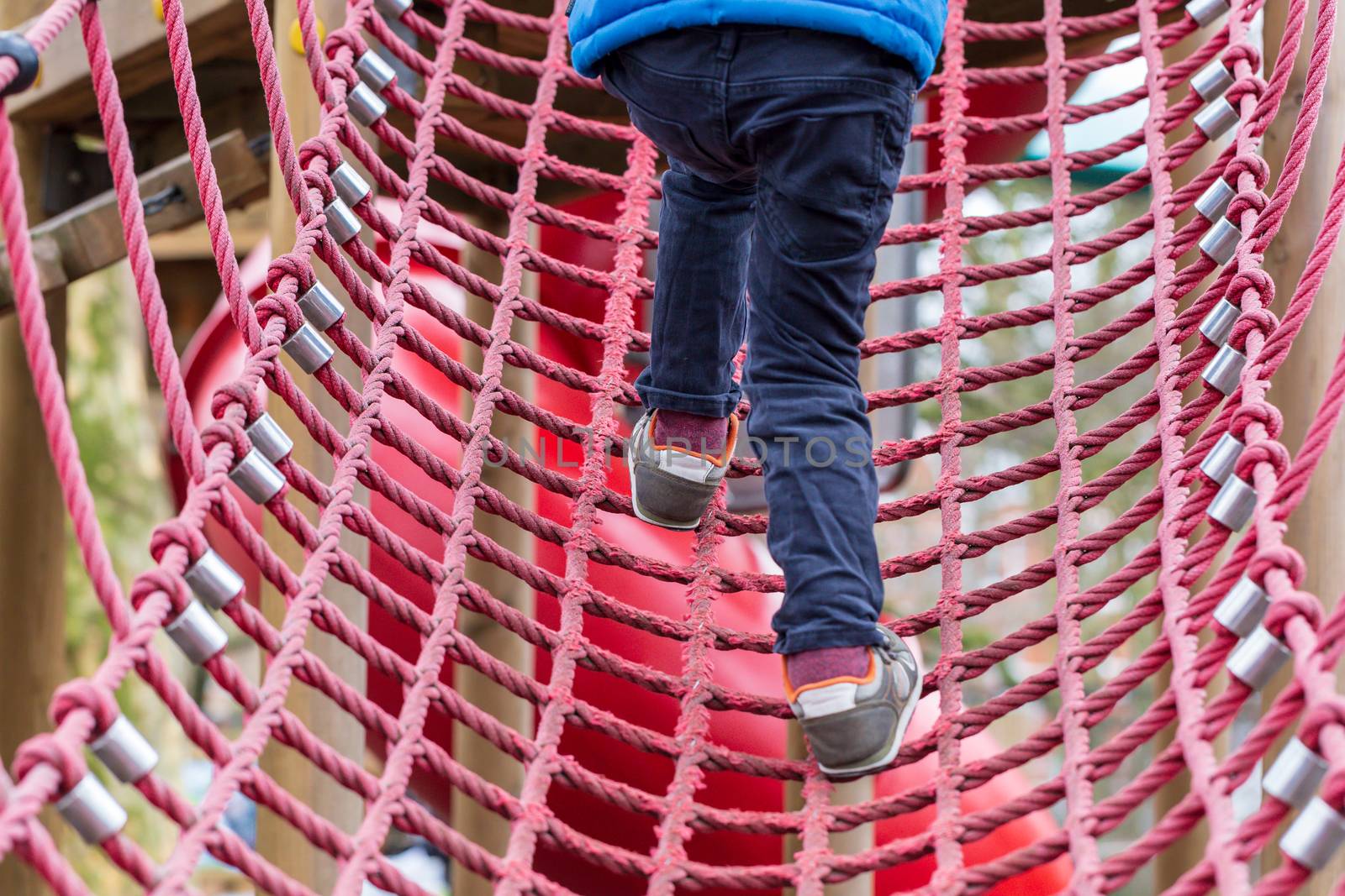 Young boy on a rope climbing frame by magicbones