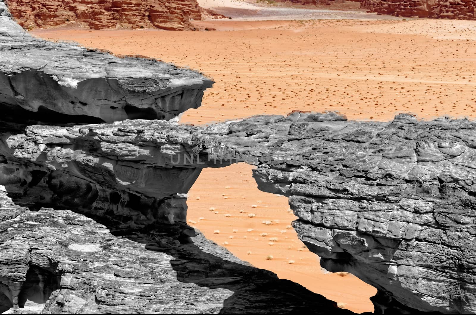 Erosion formed stone bridge, black and white alienated with colored background and abstract effect, in the nature reserve of Wadi Rum, Jordan by geogif