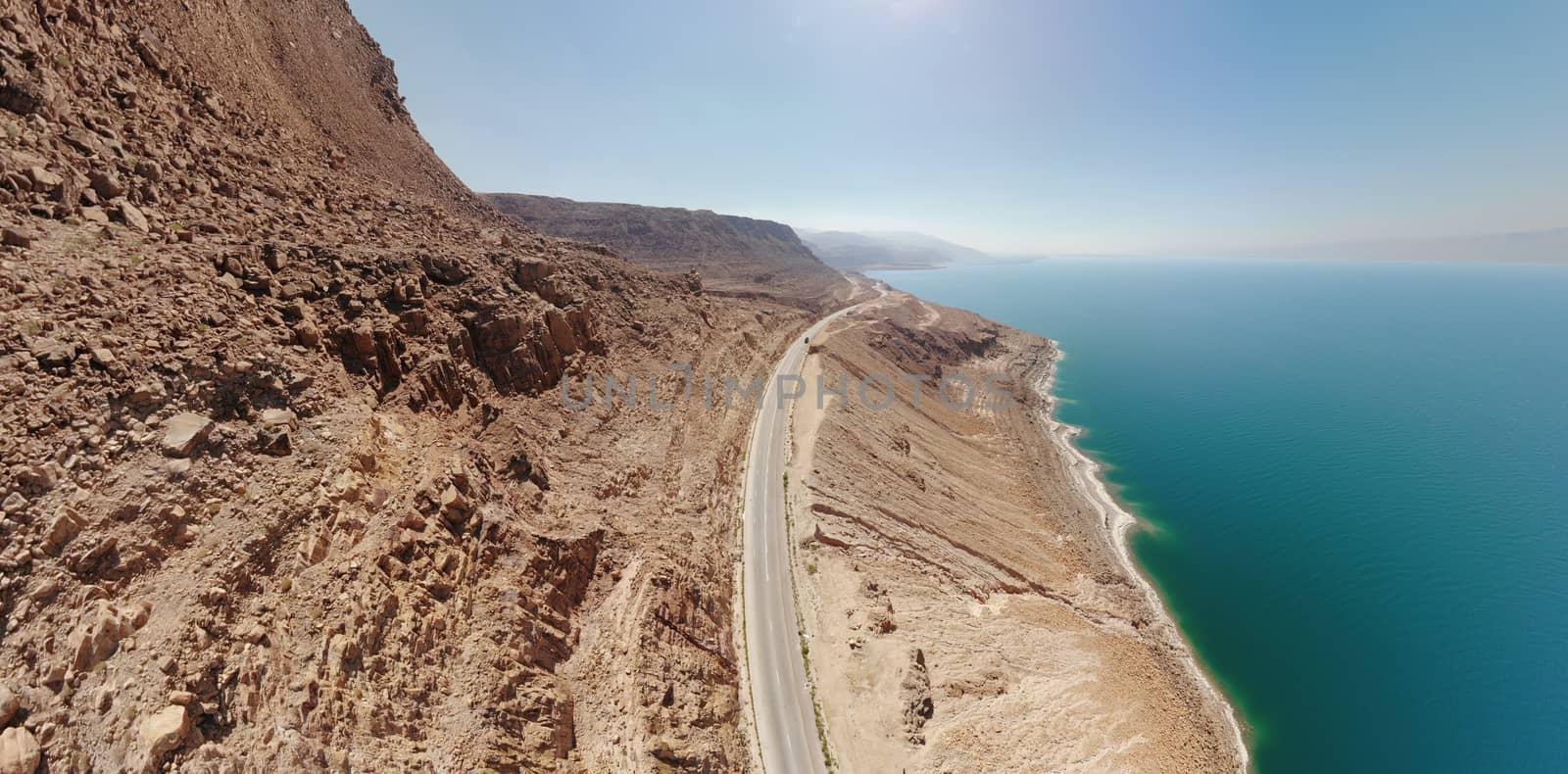 Aerial view from the main road along the Dead Sea, taken with the drone close to the rocks of the ascending mountains, Jordan