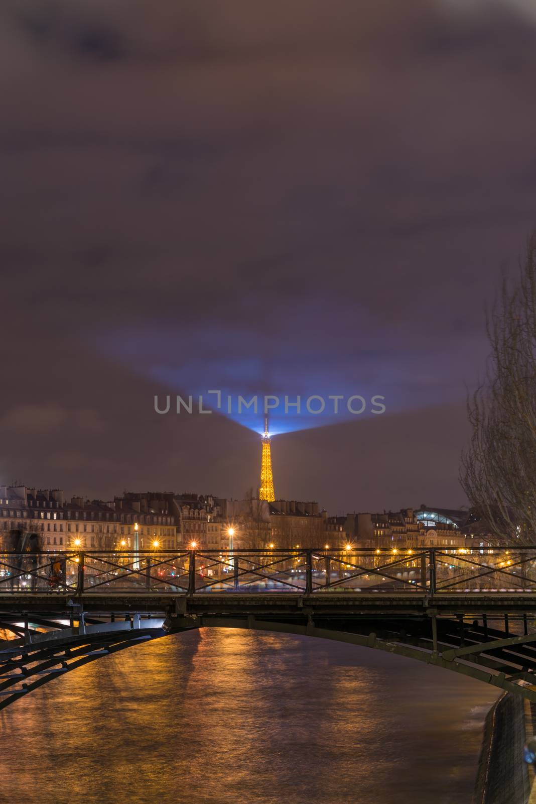 River Seine with Pont des Arts and Institut de France at night in Paris, France