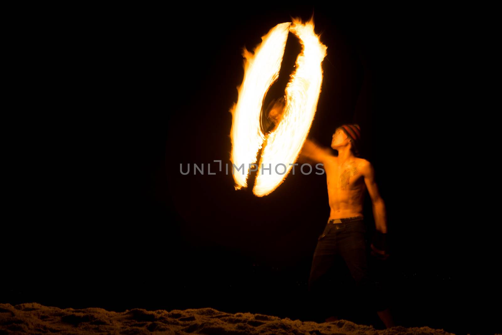 Amazing boy Fire Show at night on beach Thailand