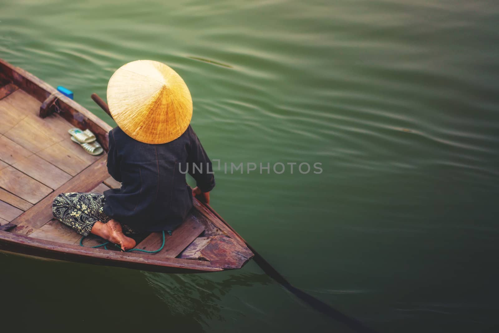 A woman rowing boat in Cai Rang Vietnam. 