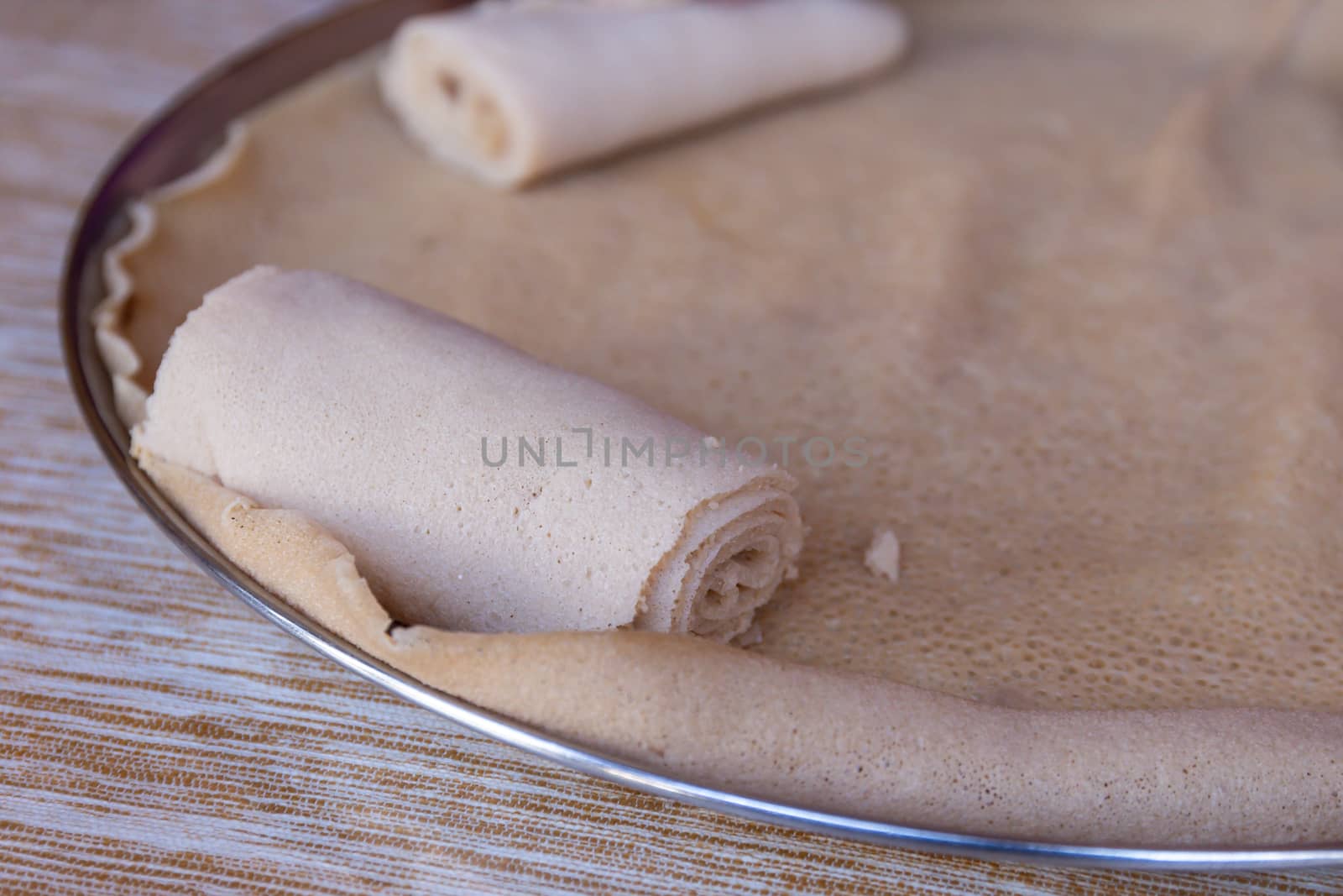 Injera is a sourdough flatbread made from teff flour.  It is the national dish of Ethiopia, Eritrea, Somalia and Djibouti