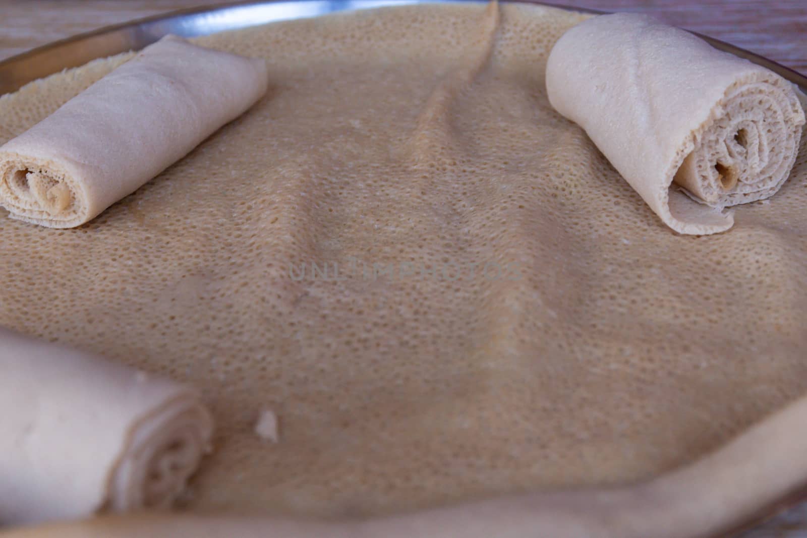 Injera is a sourdough flatbread made from teff flour.  It is the national dish of Ethiopia, Eritrea, Somalia and Djibouti