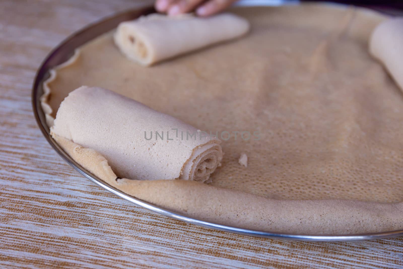 Injera is a sourdough flatbread made from teff flour.  It is the national dish of Ethiopia, Eritrea, Somalia and Djibouti