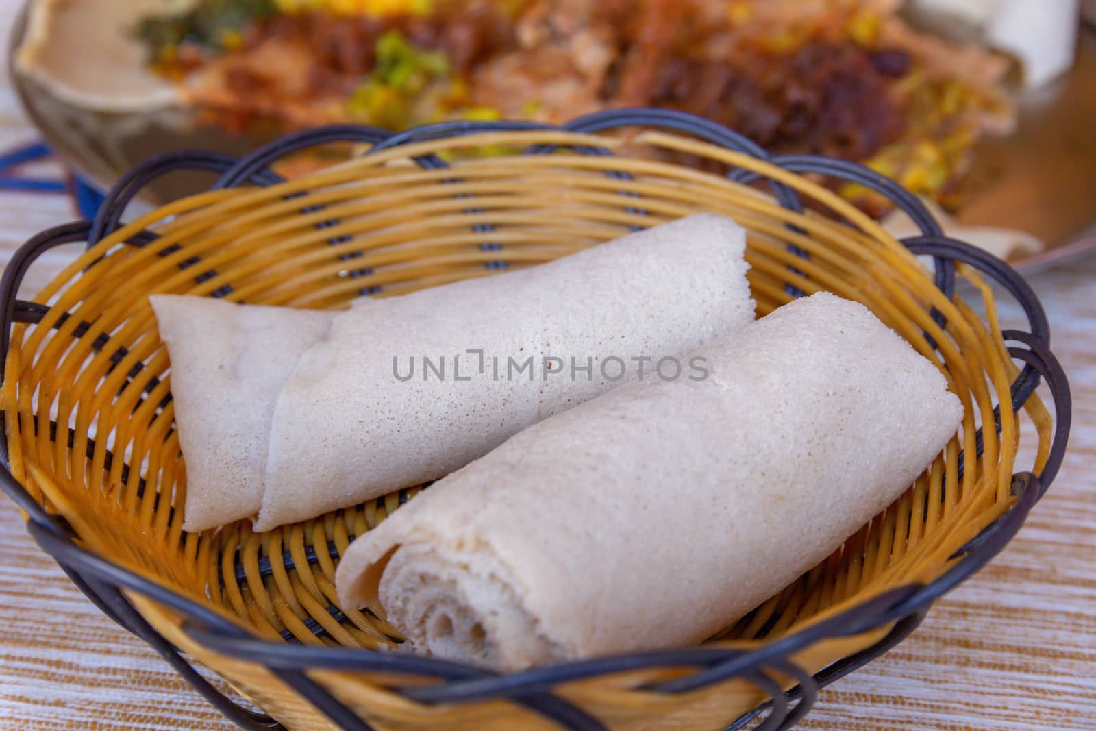 Rolls of Injera in a serving bowl.  Injera is a sourdough flatbread made from teff flour.  It is the national dish of Ethiopia, Eritrea, Somalia and Djibouti