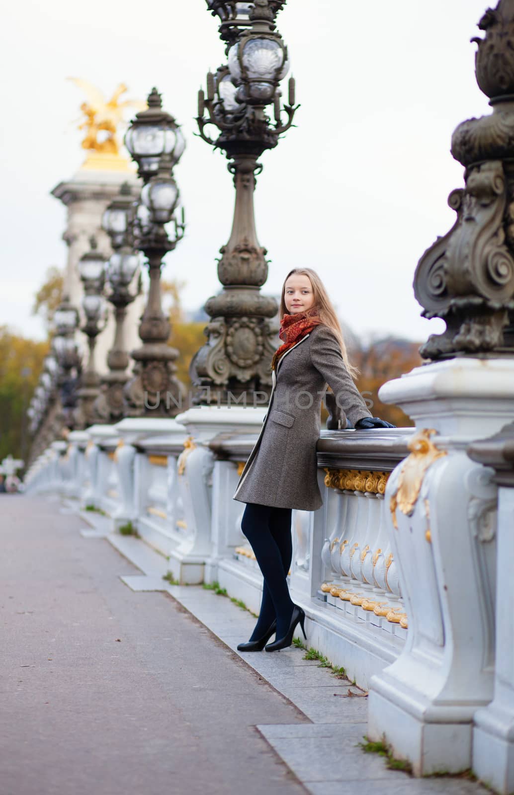 Beautiful girl with long blond hair on the Pont Alexandre III in Paris