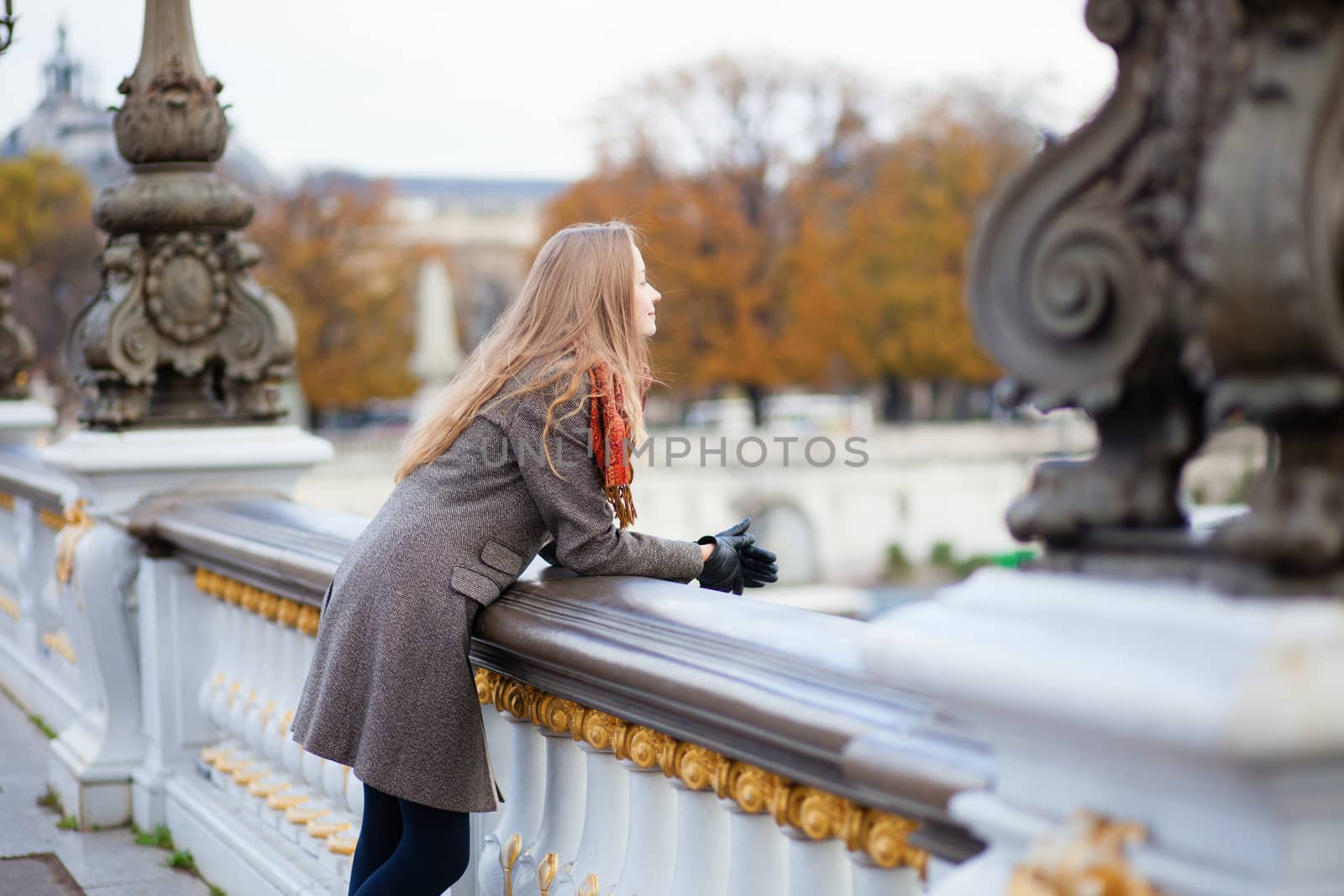 Beautiful young tourist in Paris on a fall or spring day