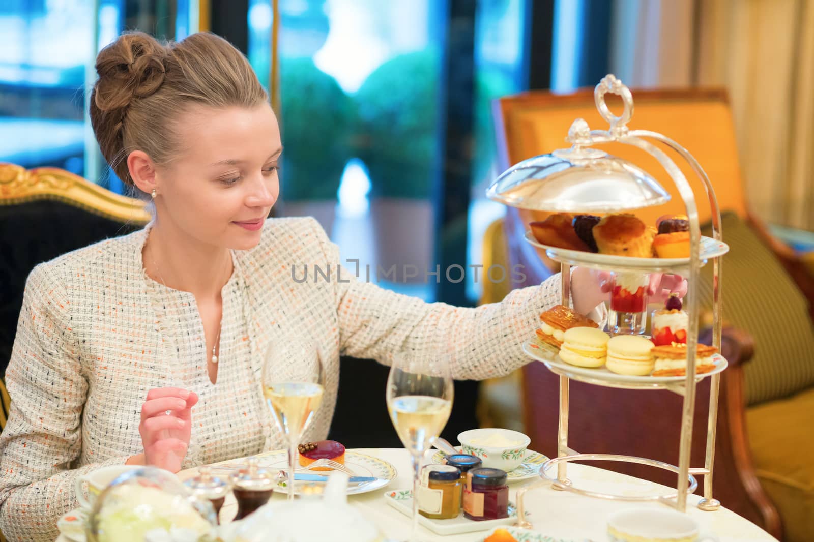 Beautiful young woman enjoying afternoon tea