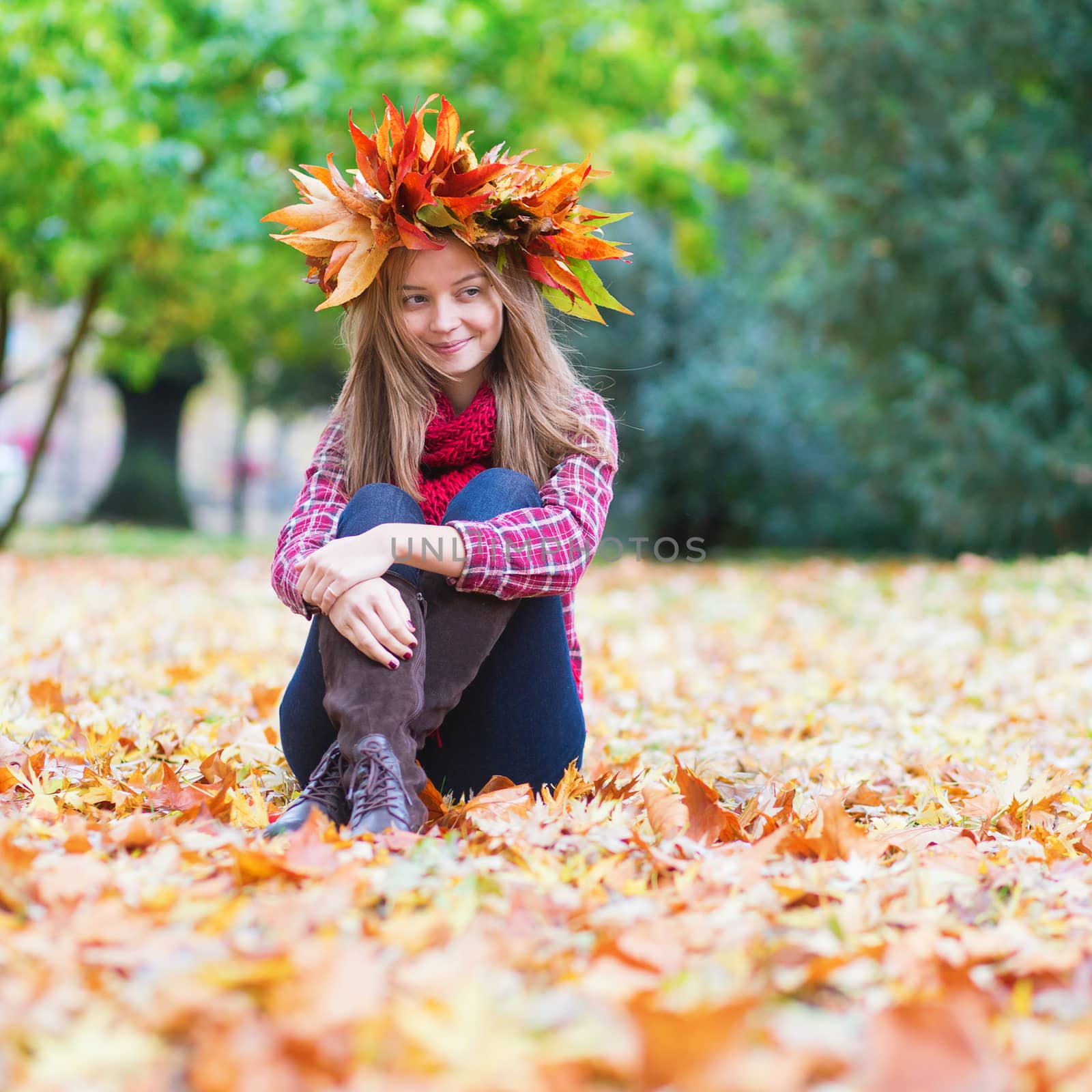 Happy young girl in park on a fall day