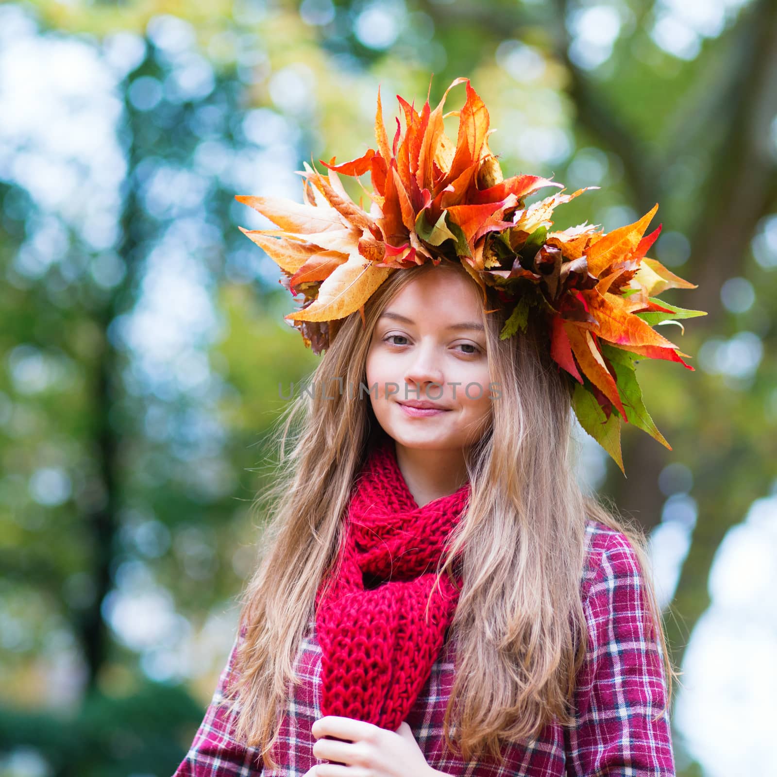 Happy young girl in park on a fall day