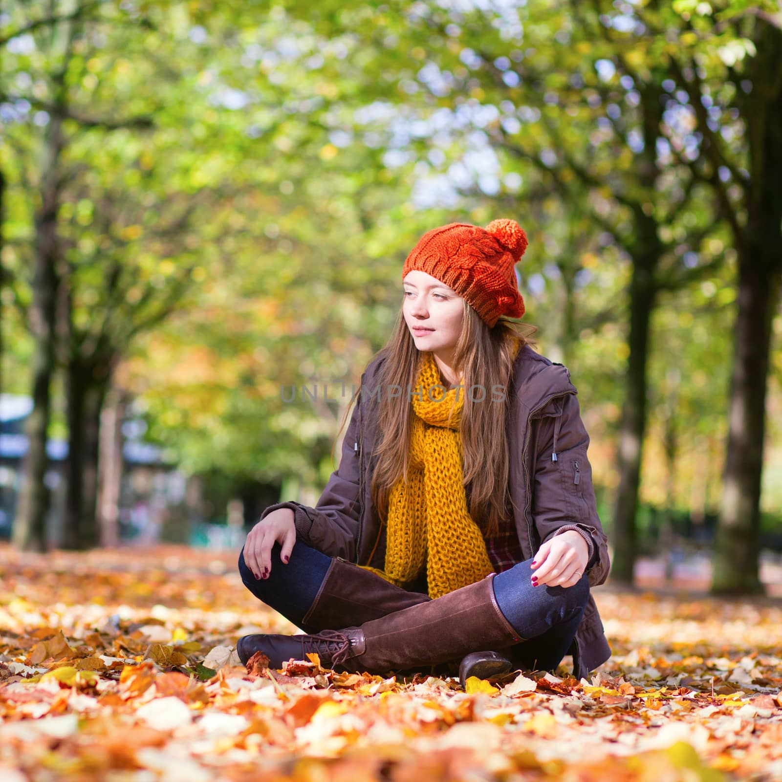 Happy young girl in park on a fall day