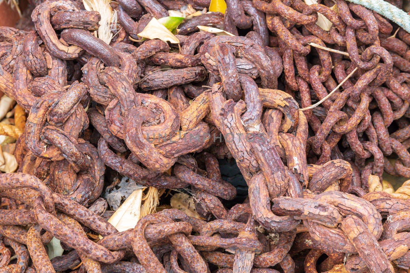 A pile of rusty chains weathered and decaying