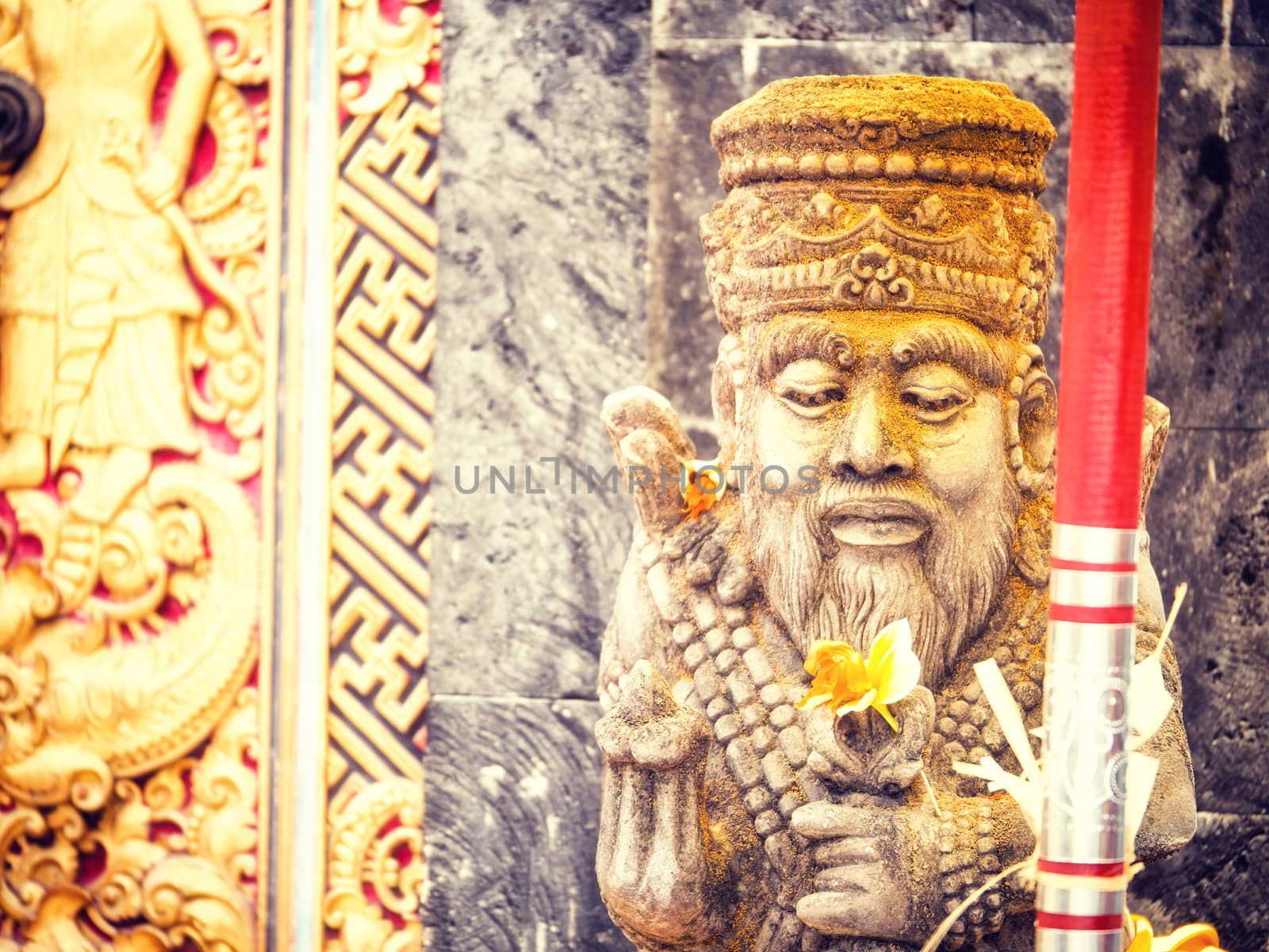 Ancient Balinese statue at the temple in Bali Indonesia