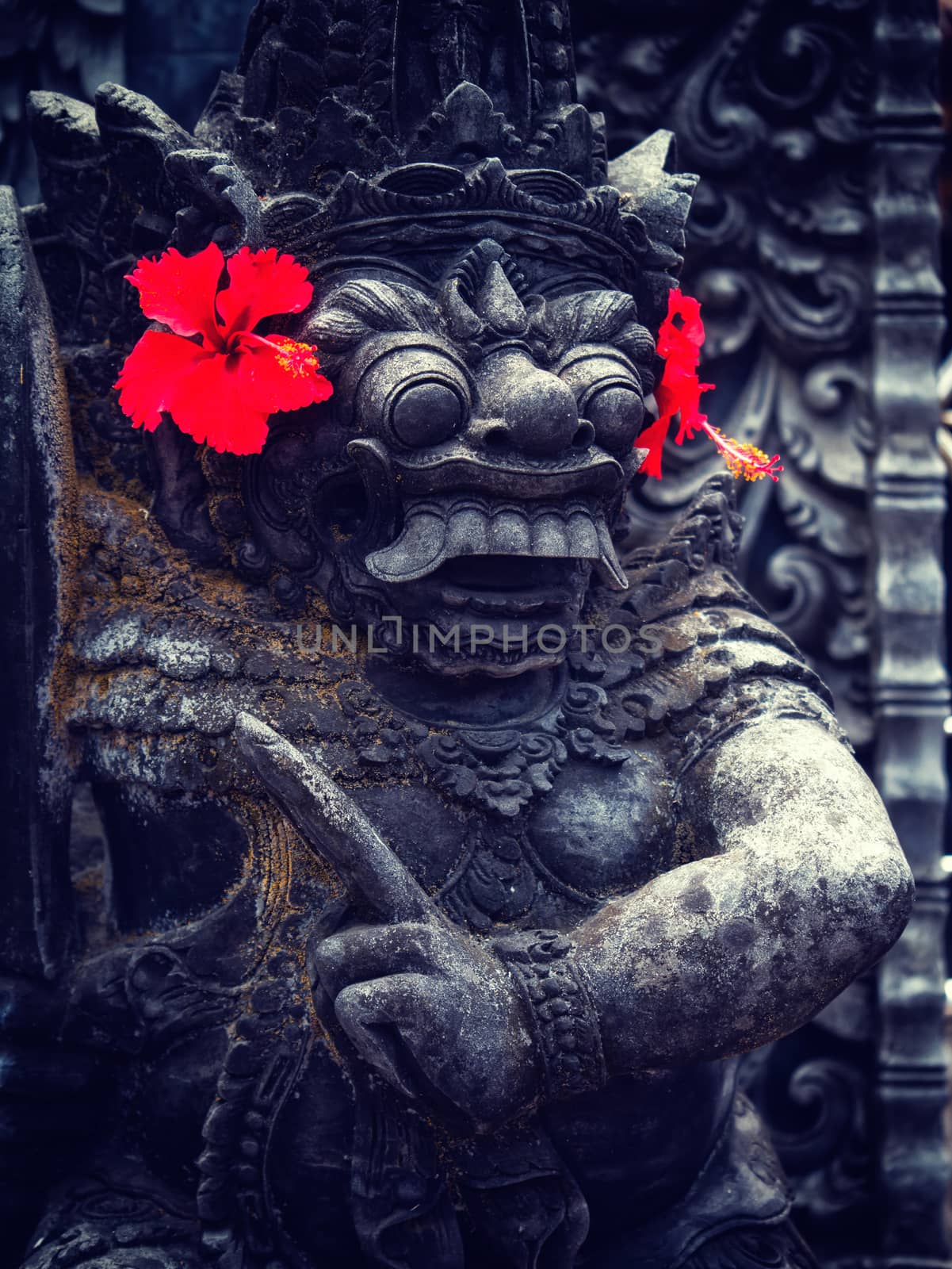 Ancient Balinese statue at the temple in Bali Indonesia