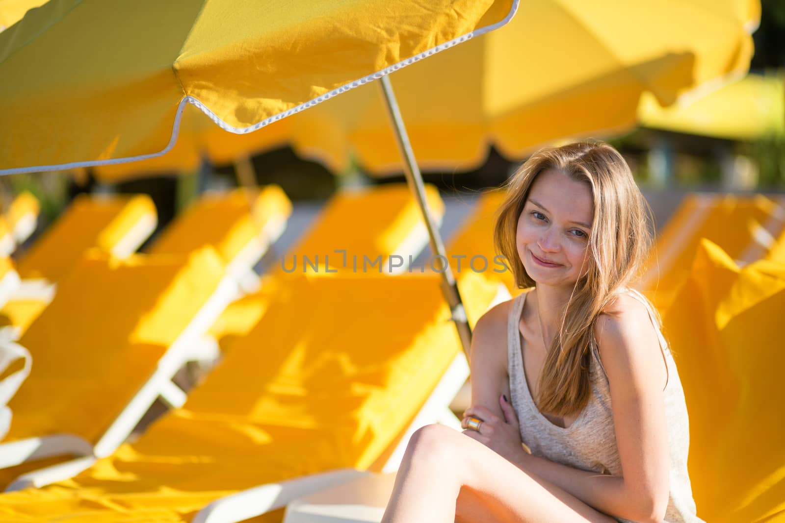 Beautiful girl relaxing on a beach chair near the sea