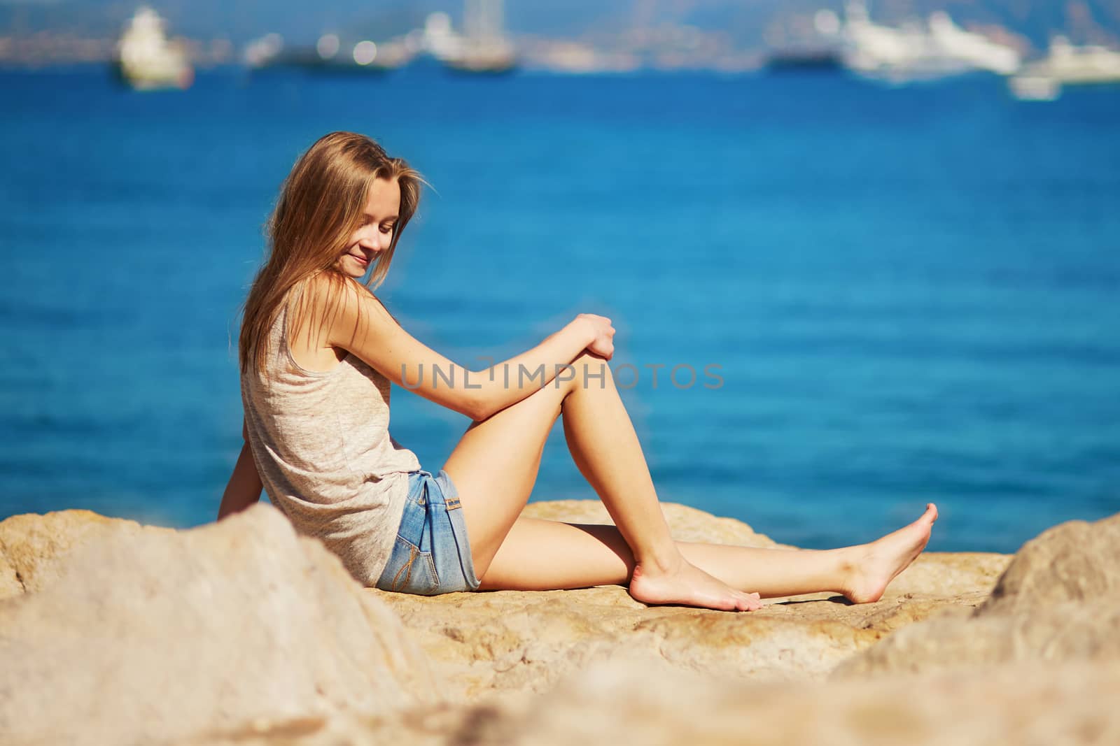 Beautiful young woman enjoying her vacation by the sea