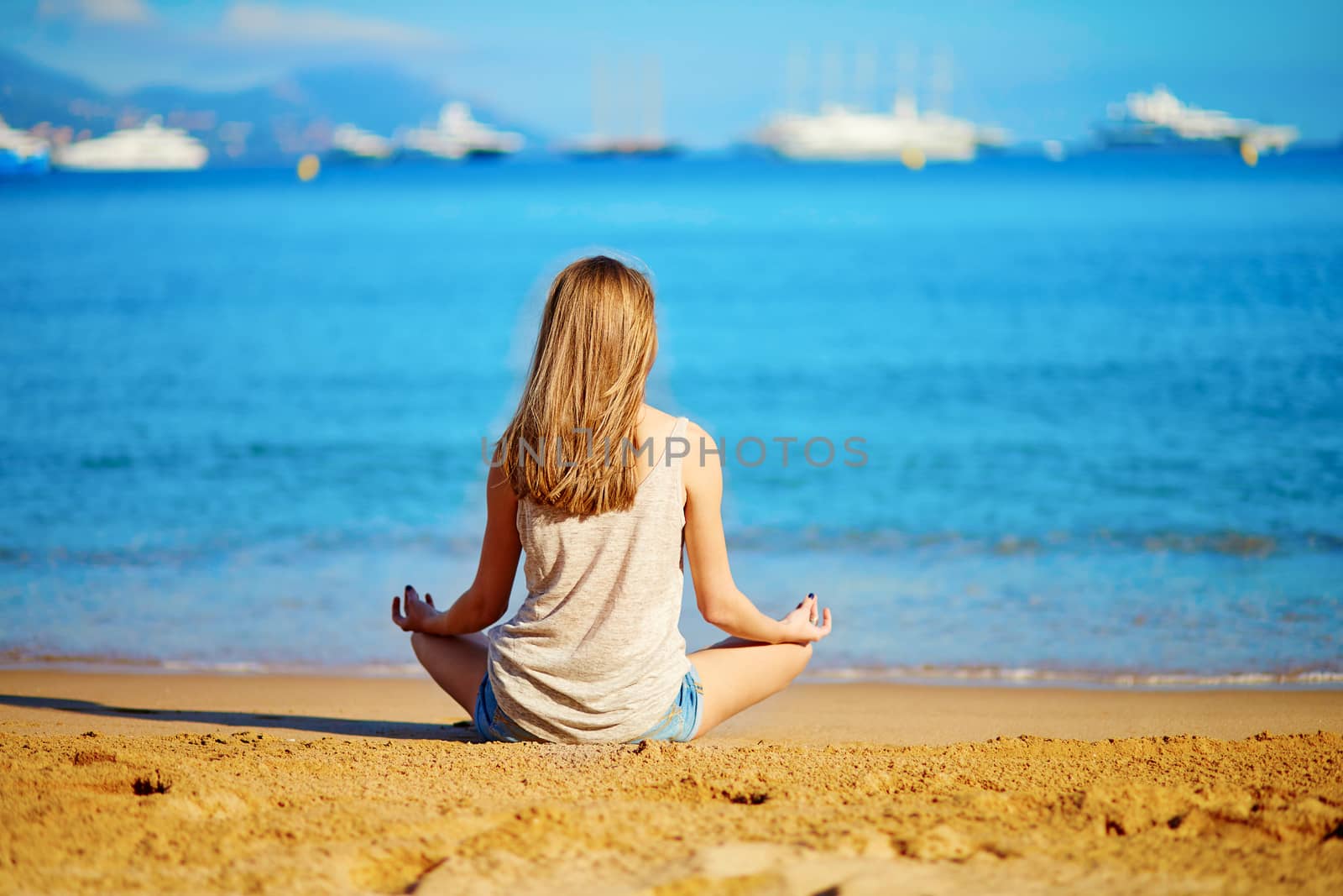 Young girl enjoying her vacation by the sea  by jaspe