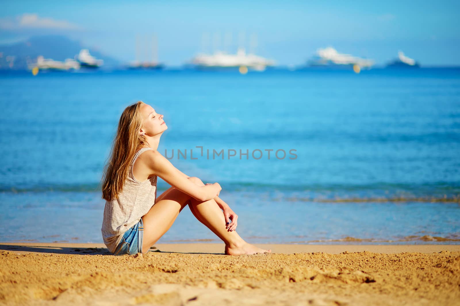 Beautiful young girl enjoying her vacation by the sea 