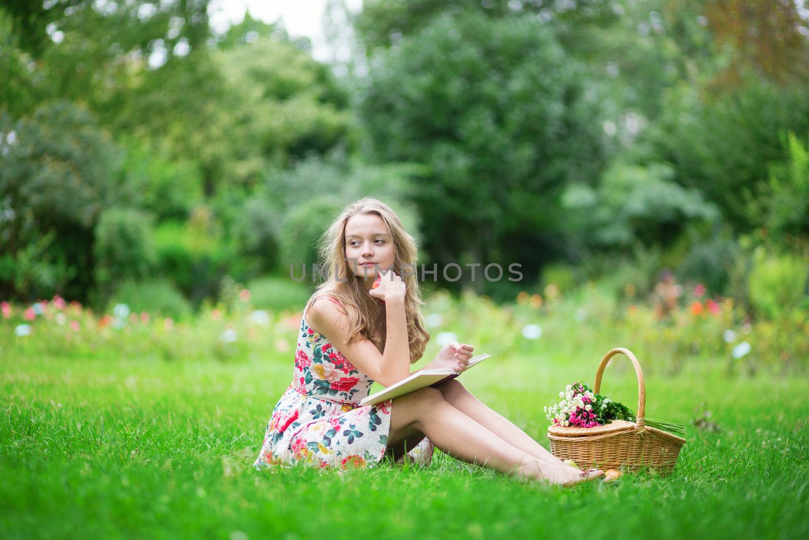 Beautiful young girl in the countryside, reading a book 