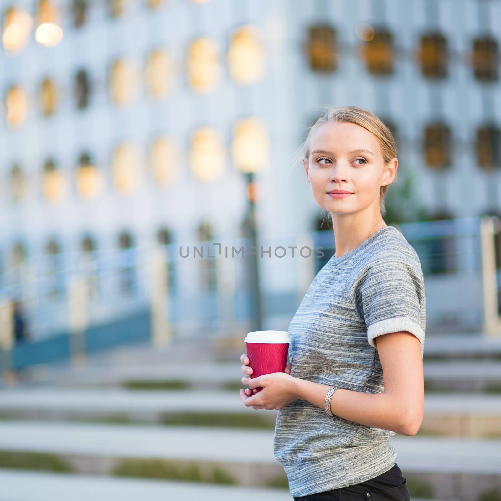 Young business woman drinking coffee outdoors by jaspe