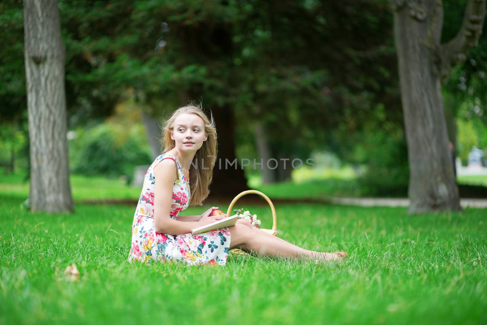 Beautiful young girl in the countryside, reading a book 