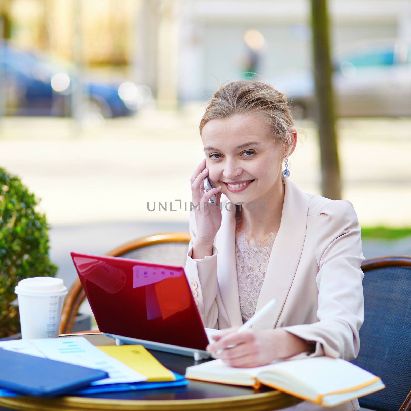 Young businesswoman on a coffee break, working on her laptop