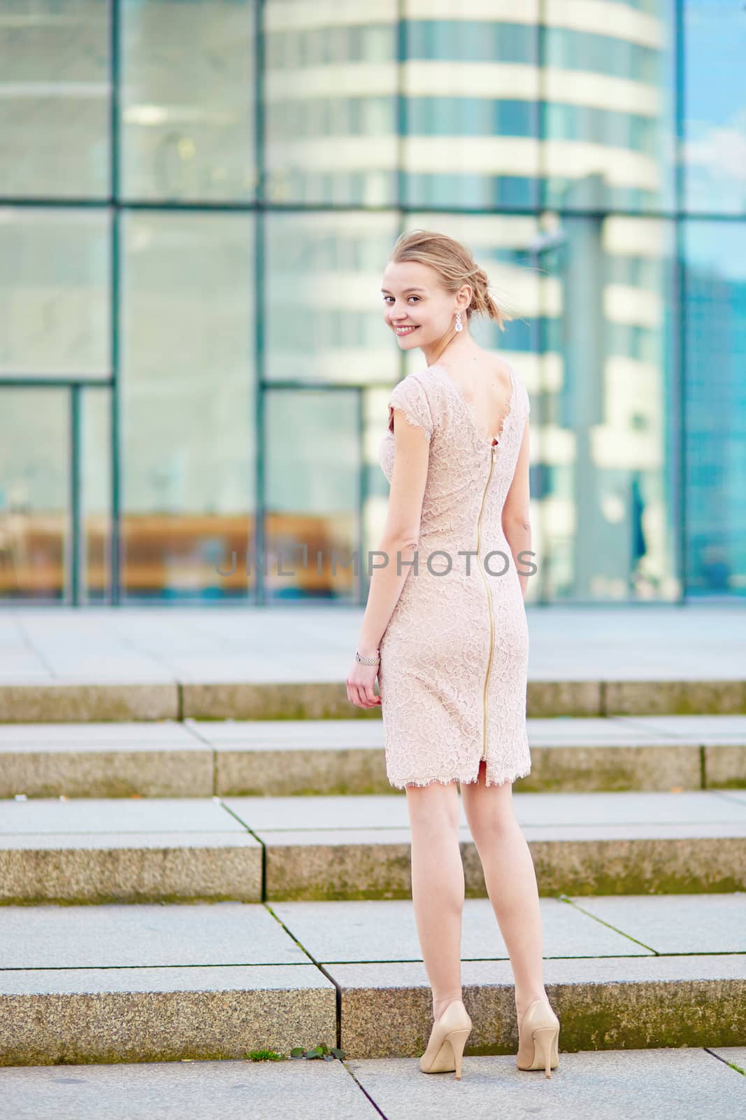 Beautiful young business woman in modern glass office interior