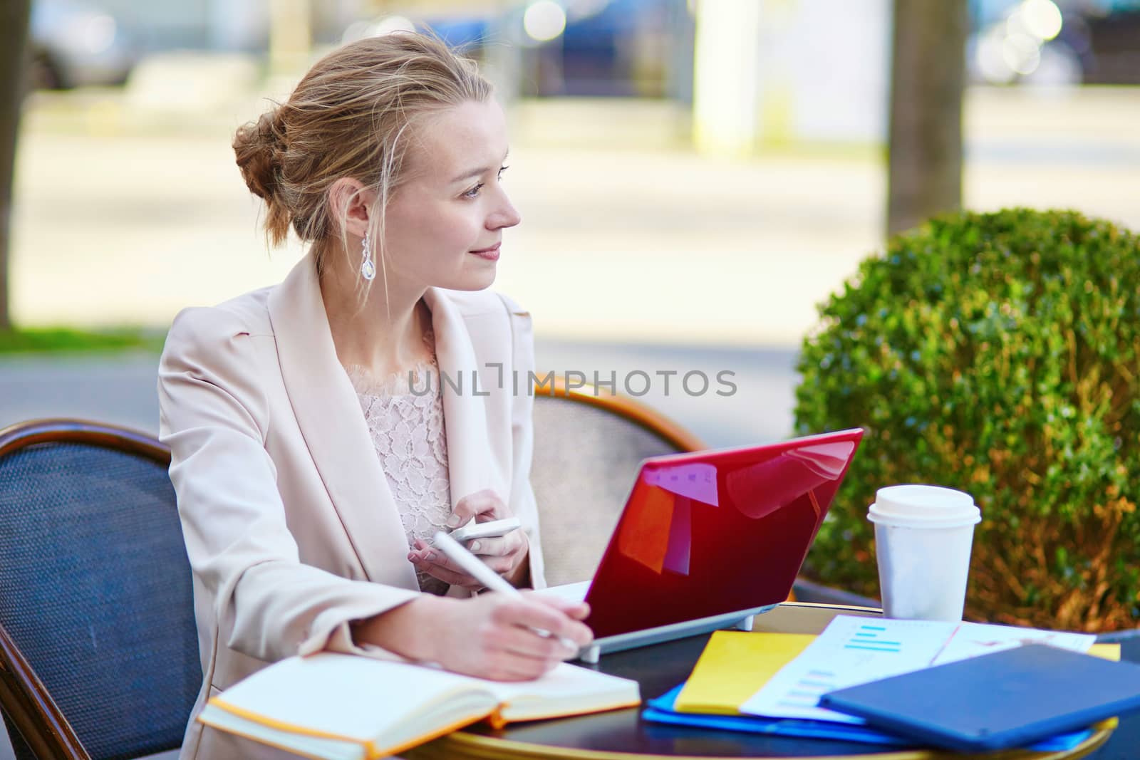 Young businesswoman on a coffee break, working on her laptop. Quarantine and closed offices during coronavirus outbreak