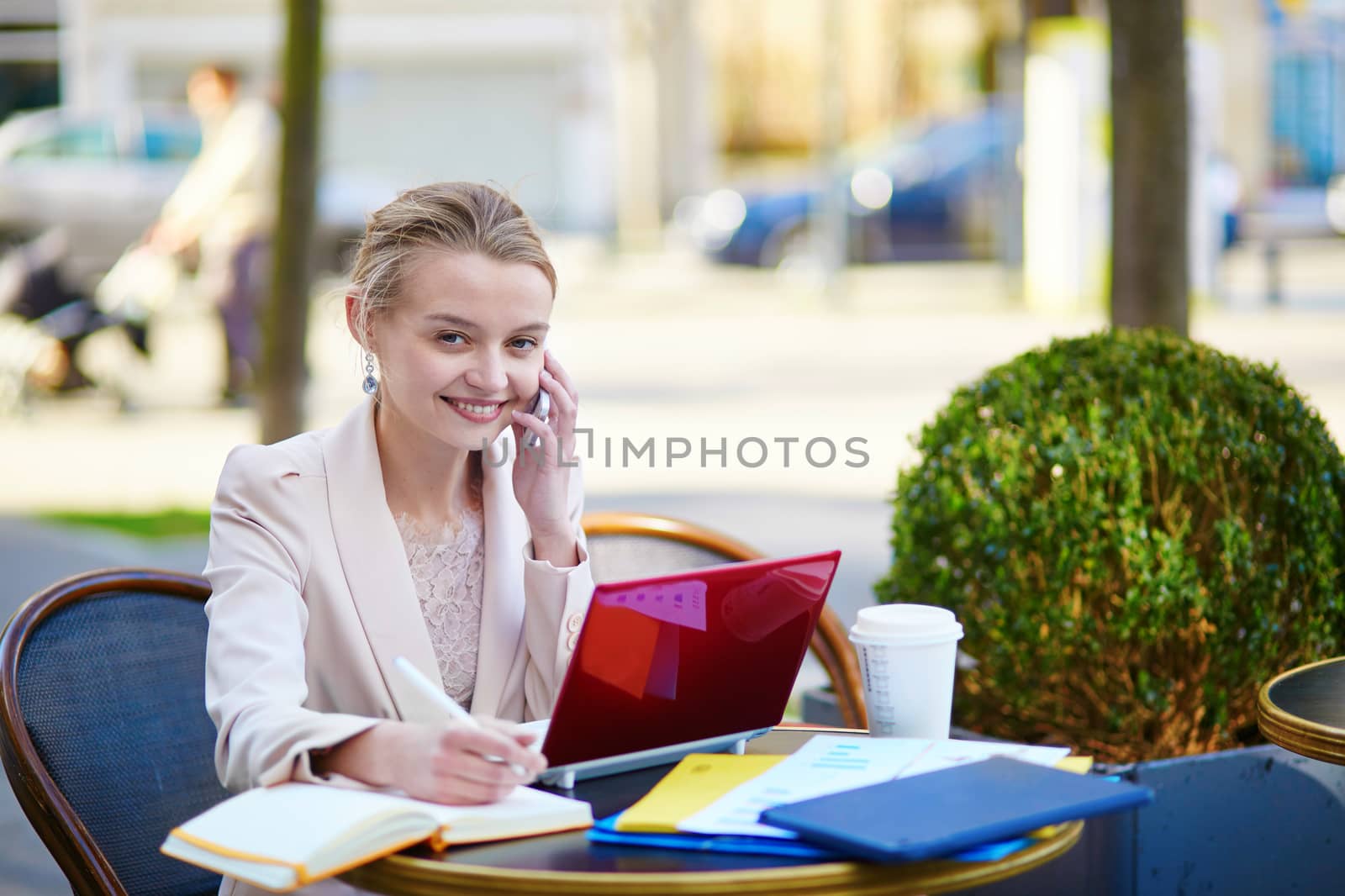 Young businesswoman on a coffee break, working on her laptop