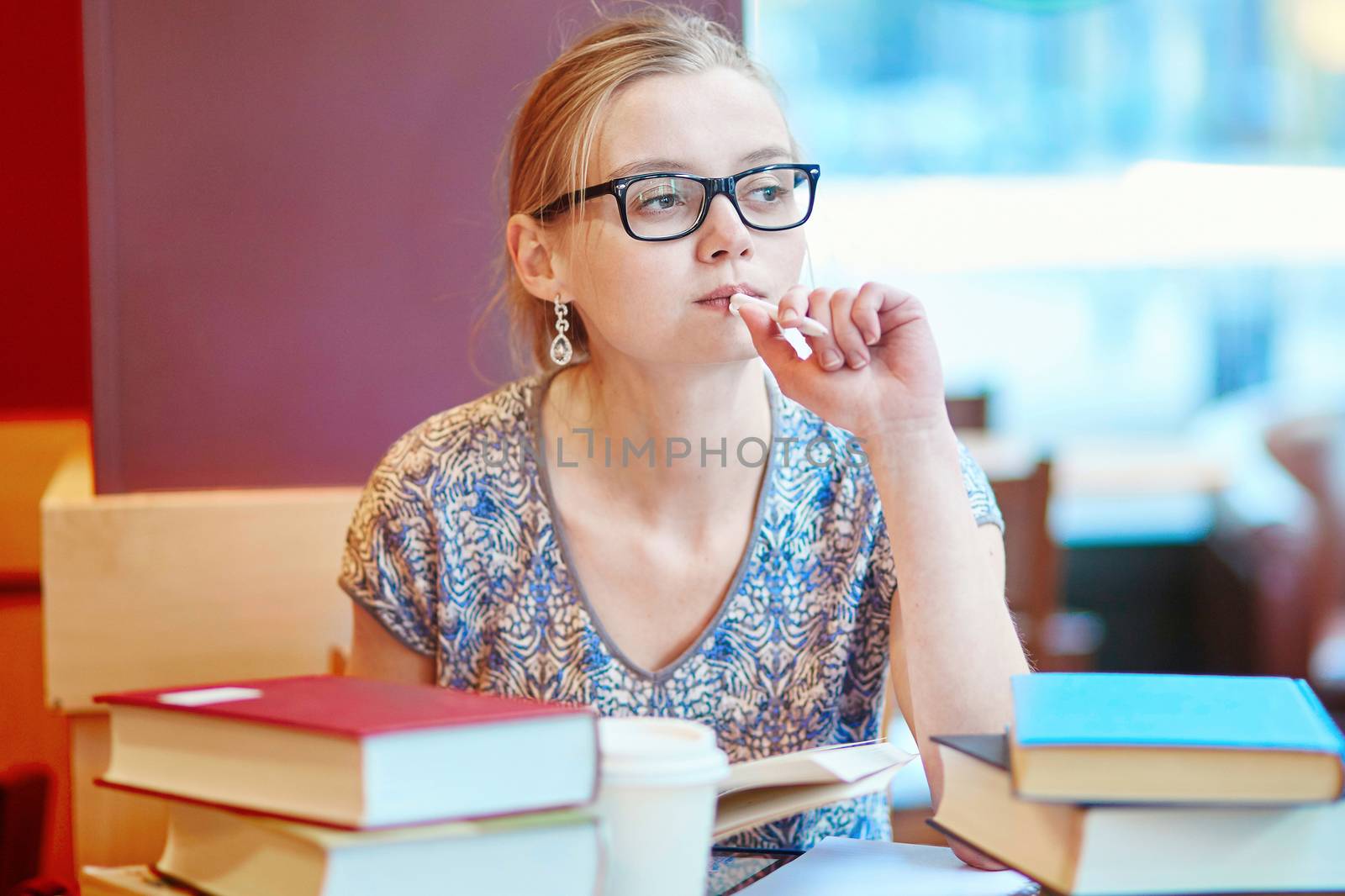 Student with books and papers, studying at home. Quarantine and closed schools and offices during coronavirus outbreak. Homeschooling, distance learning and freelance job