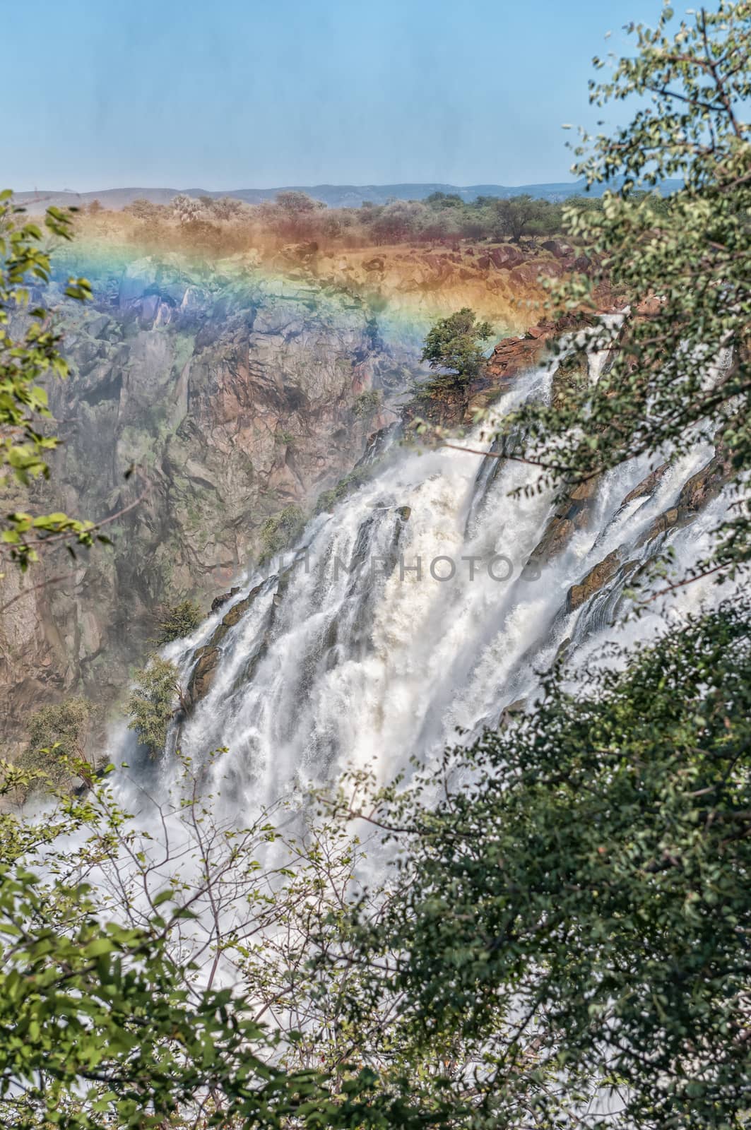 Part of the Ruacana waterfall in the Kunene River. A rainbow is visible