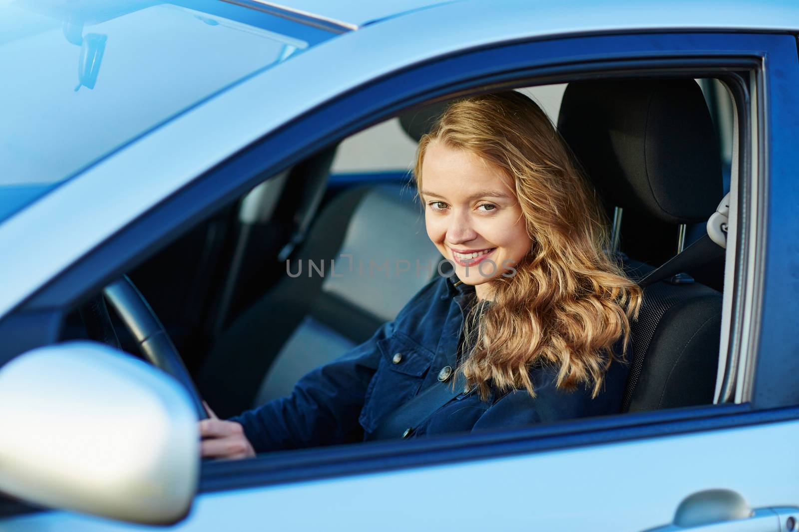 Beautiful and confident young woman driving a car