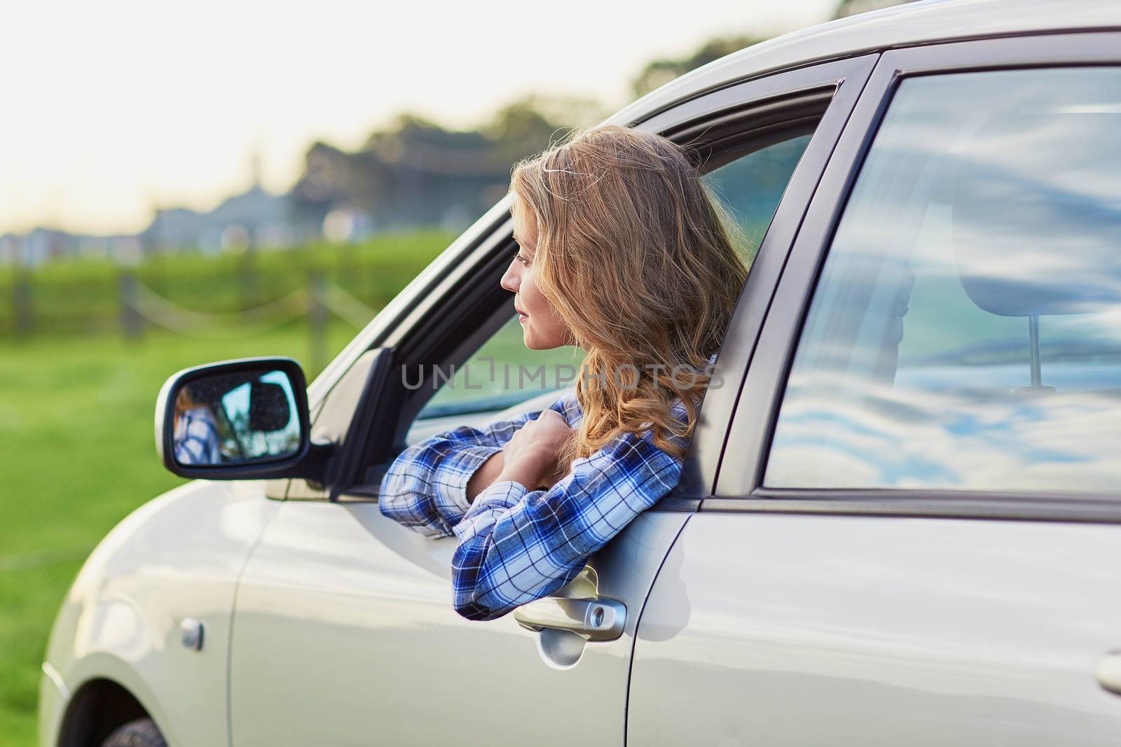Beautiful young confident woman driving a car