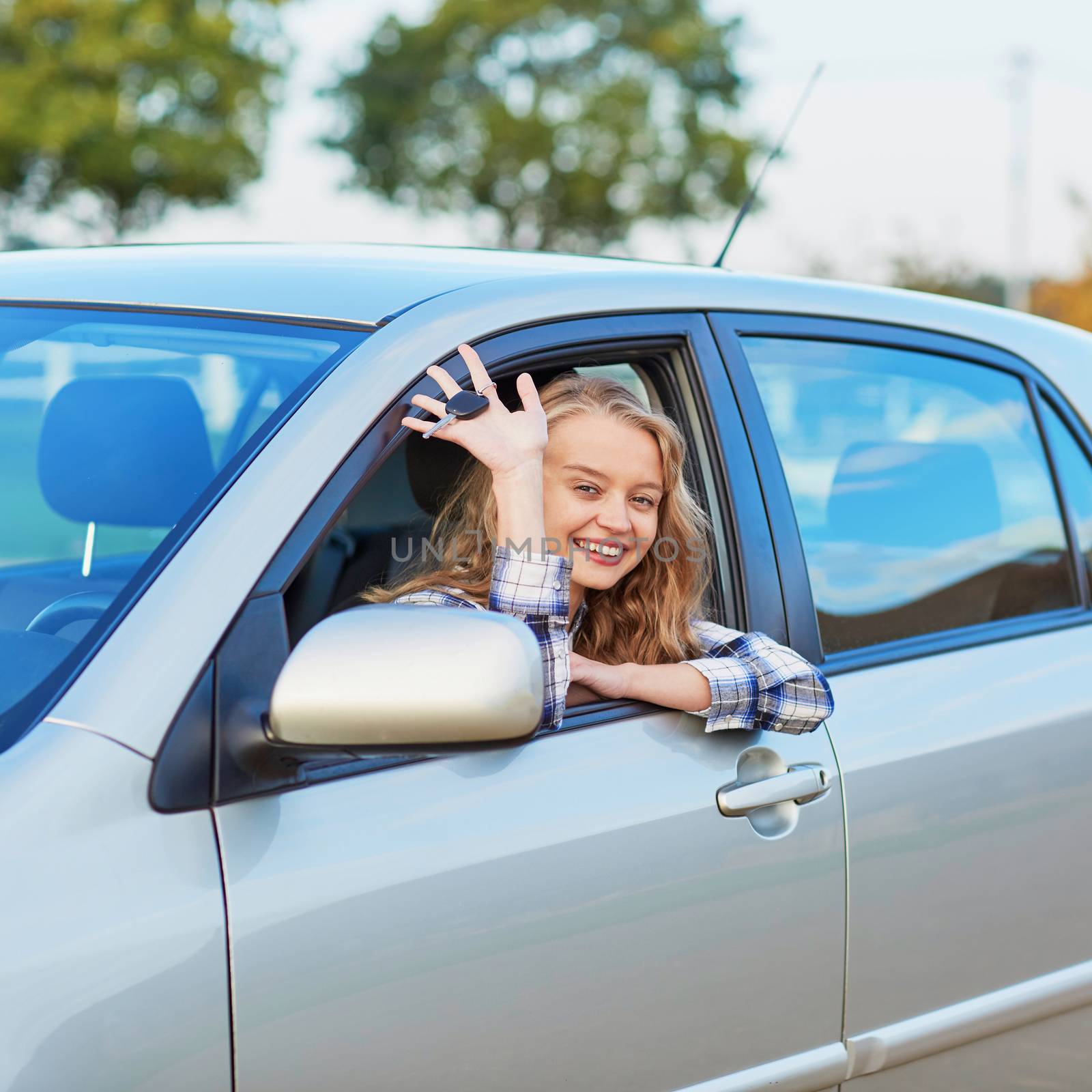 Beautiful young confident woman driving a car