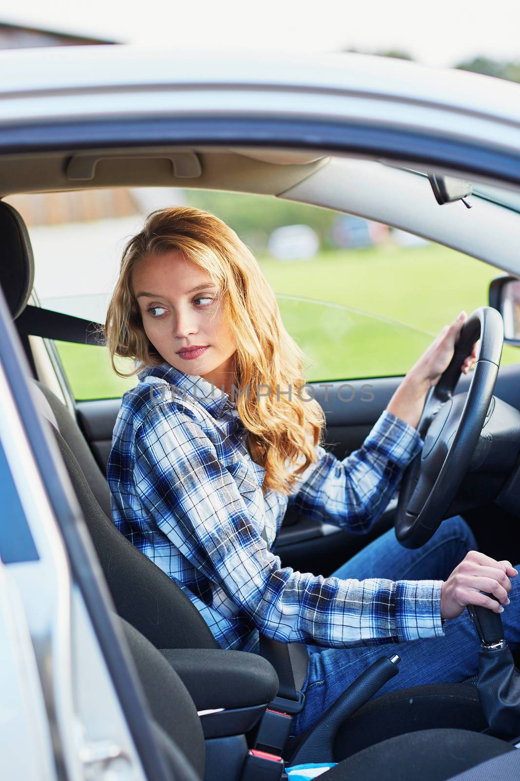 Beautiful and confident young woman driving a car