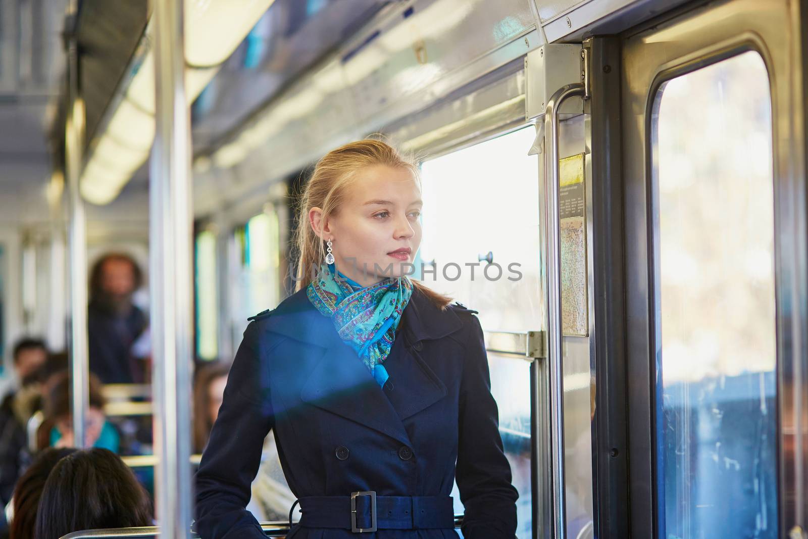 Beautiful young woman travelling in a train of Parisian underground