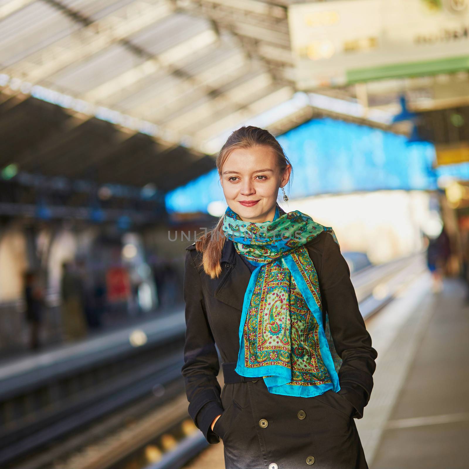 Beautiful young woman waiting for a train  by jaspe