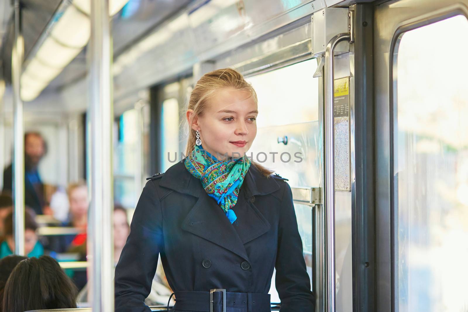 Beautiful young woman travelling in a train of Parisian underground