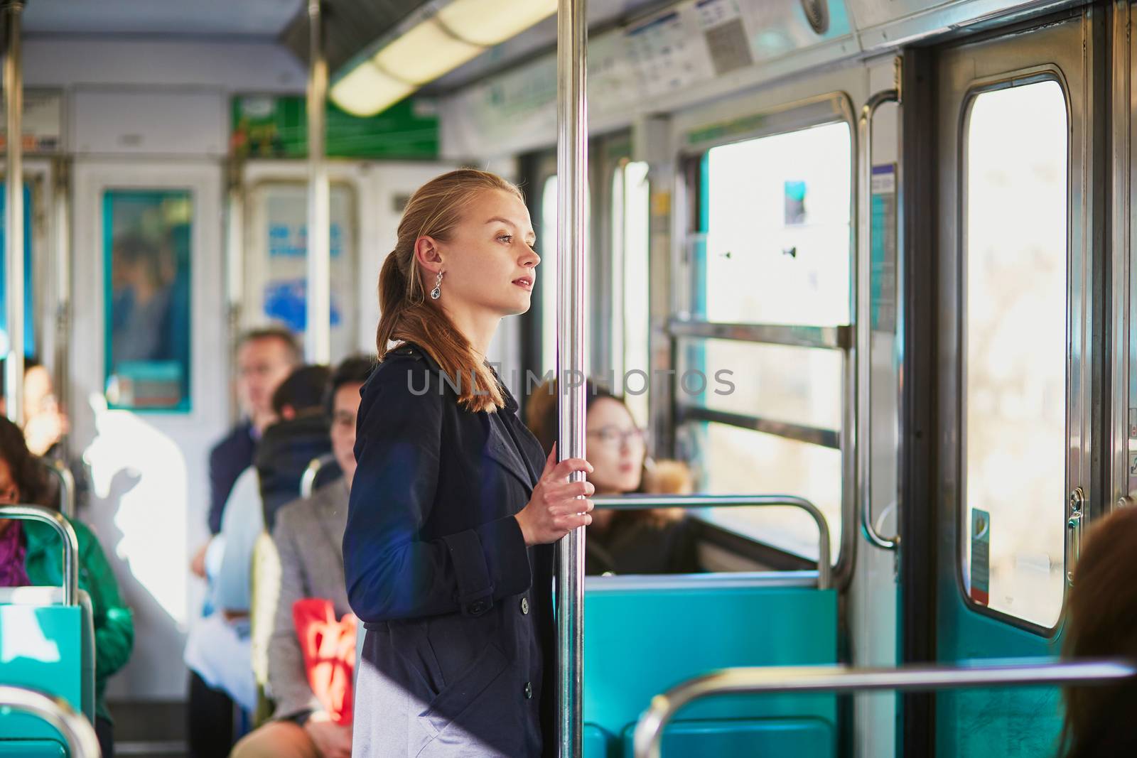 Beautiful young woman travelling in a train of Parisian underground