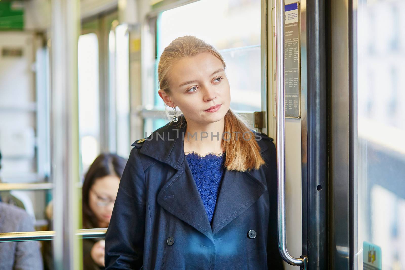 Beautiful young woman travelling in a train of Parisian underground