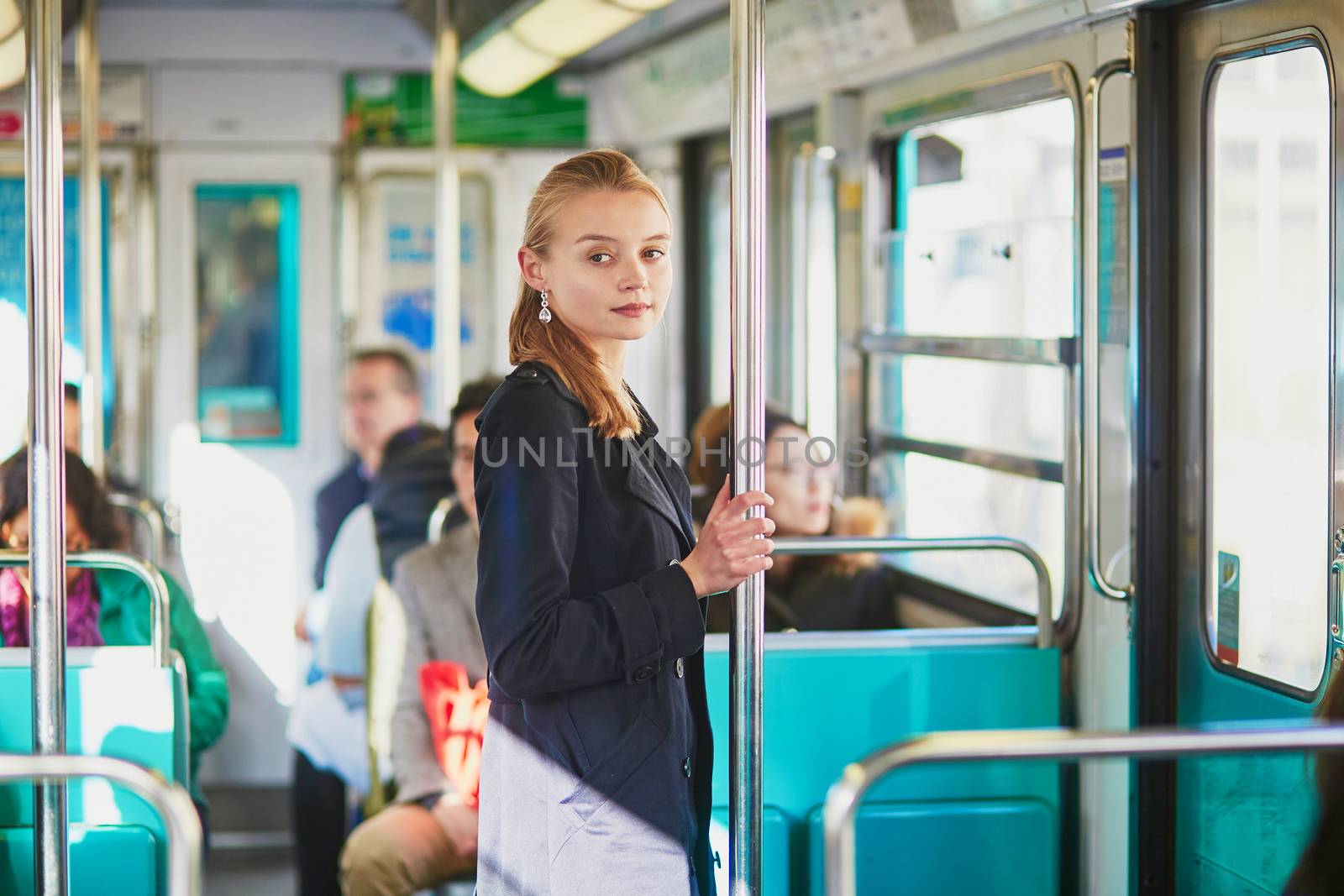 Beautiful young woman travelling in a train of Parisian underground