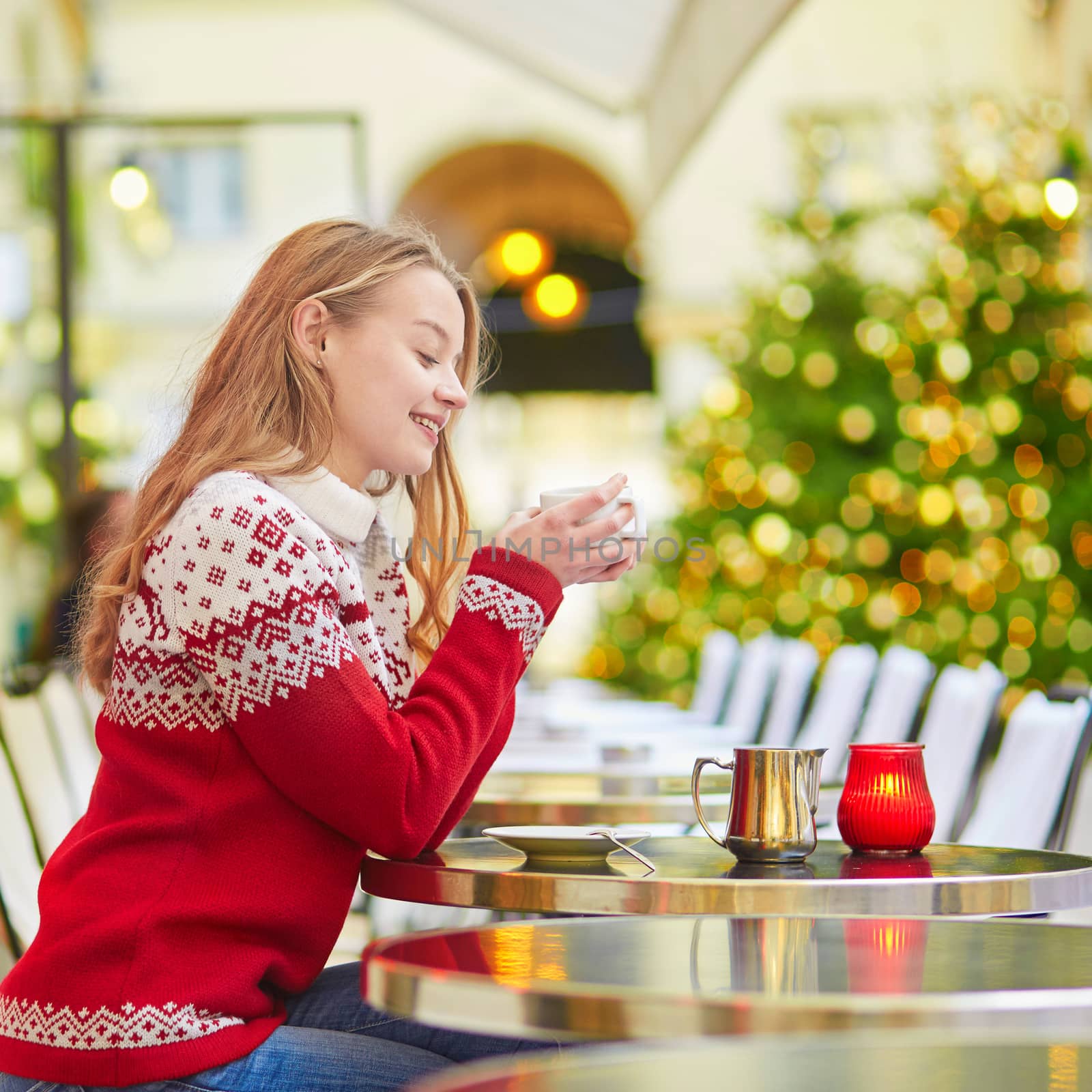 Beautiful young girl in an outdoor Parisian cafe by jaspe