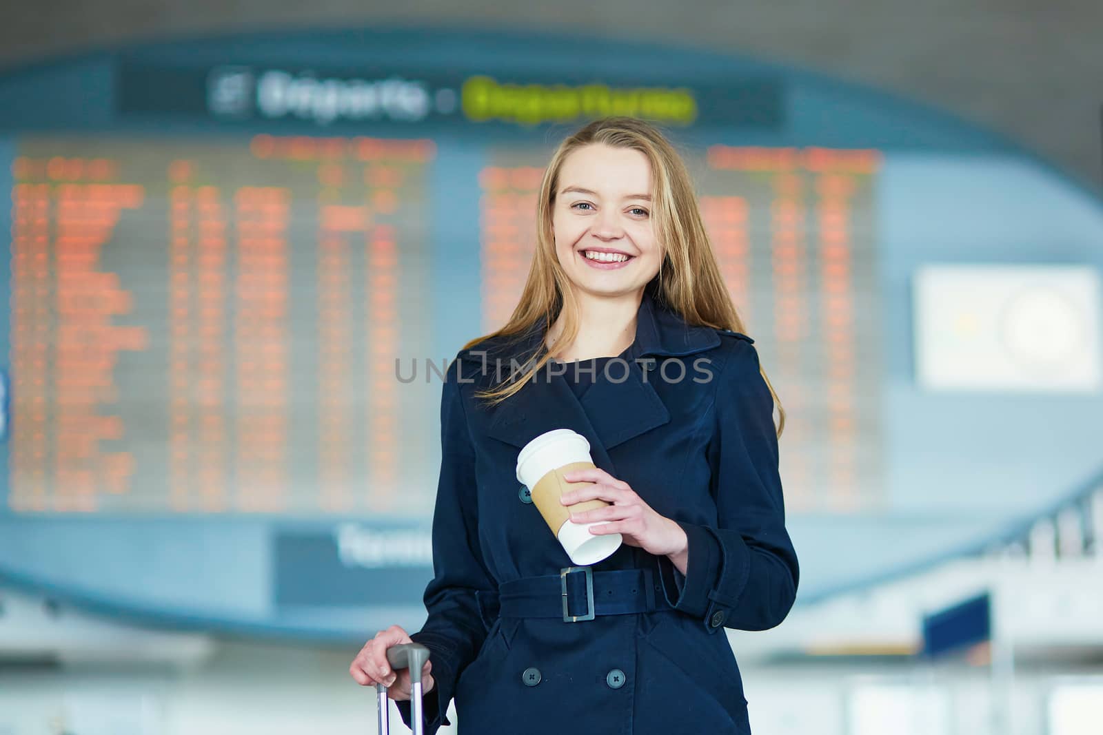 Young female traveler in international airport by jaspe