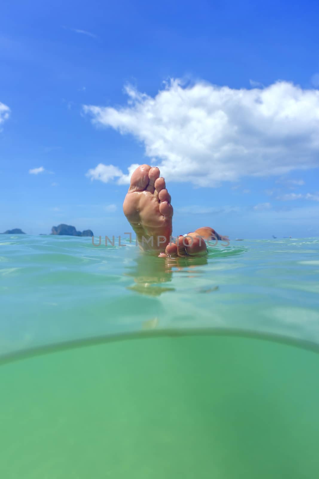 Woman feet in the Andaman sea