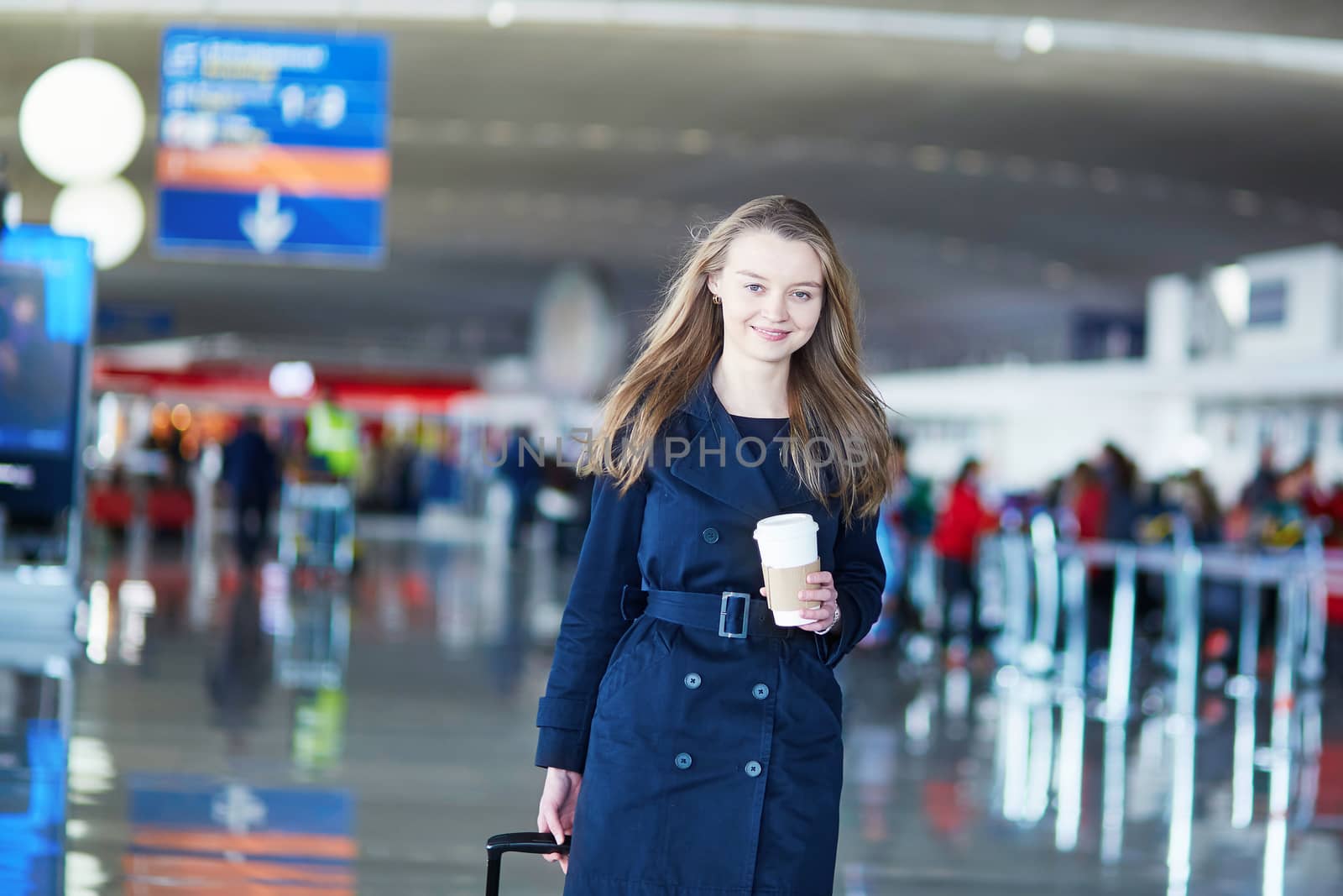 Young female traveler in international airport by jaspe