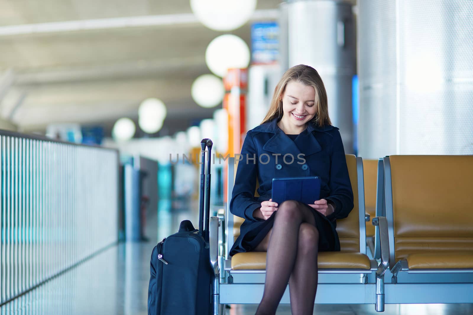 Young female traveler in international airport by jaspe