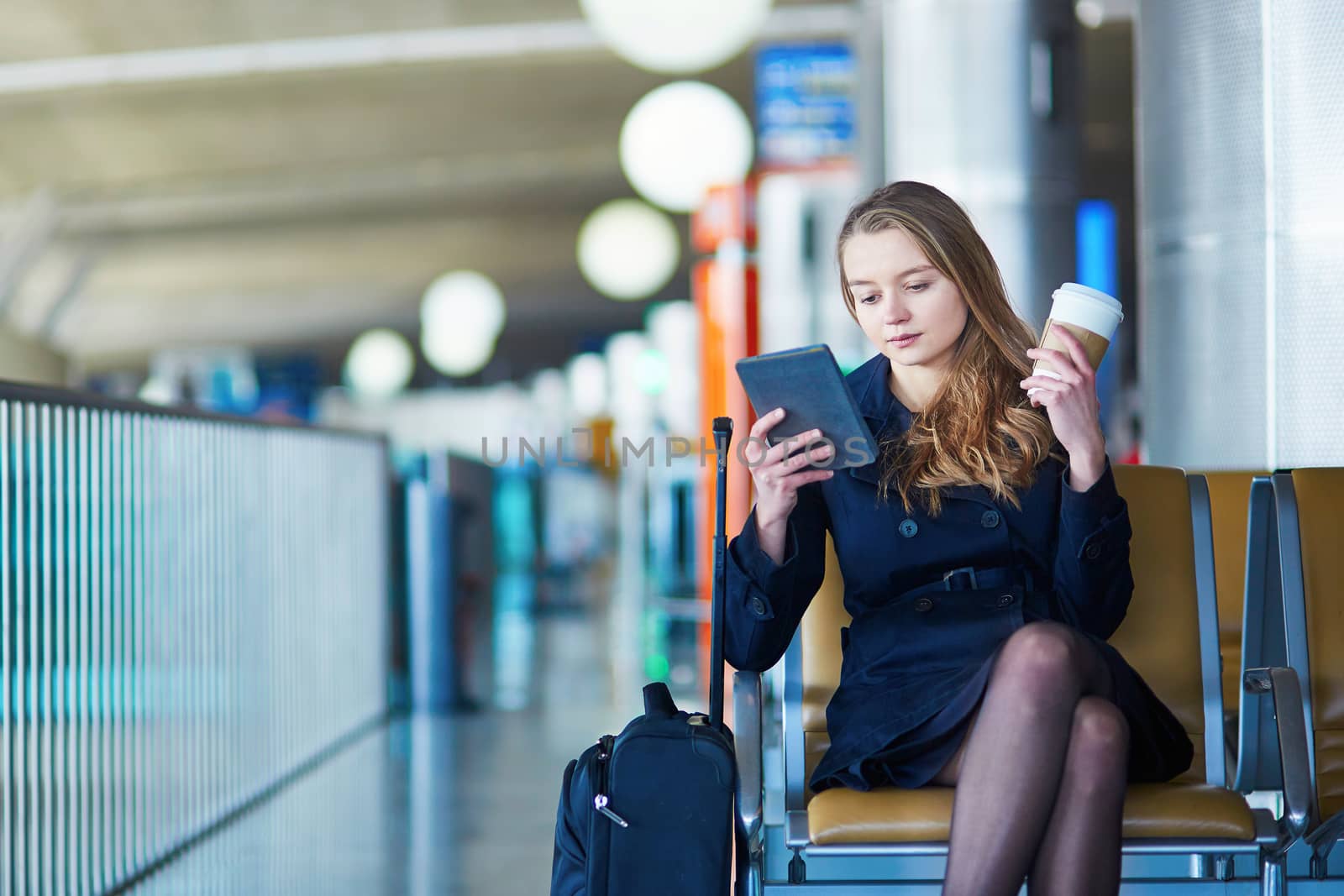 Young female traveler in international airport by jaspe